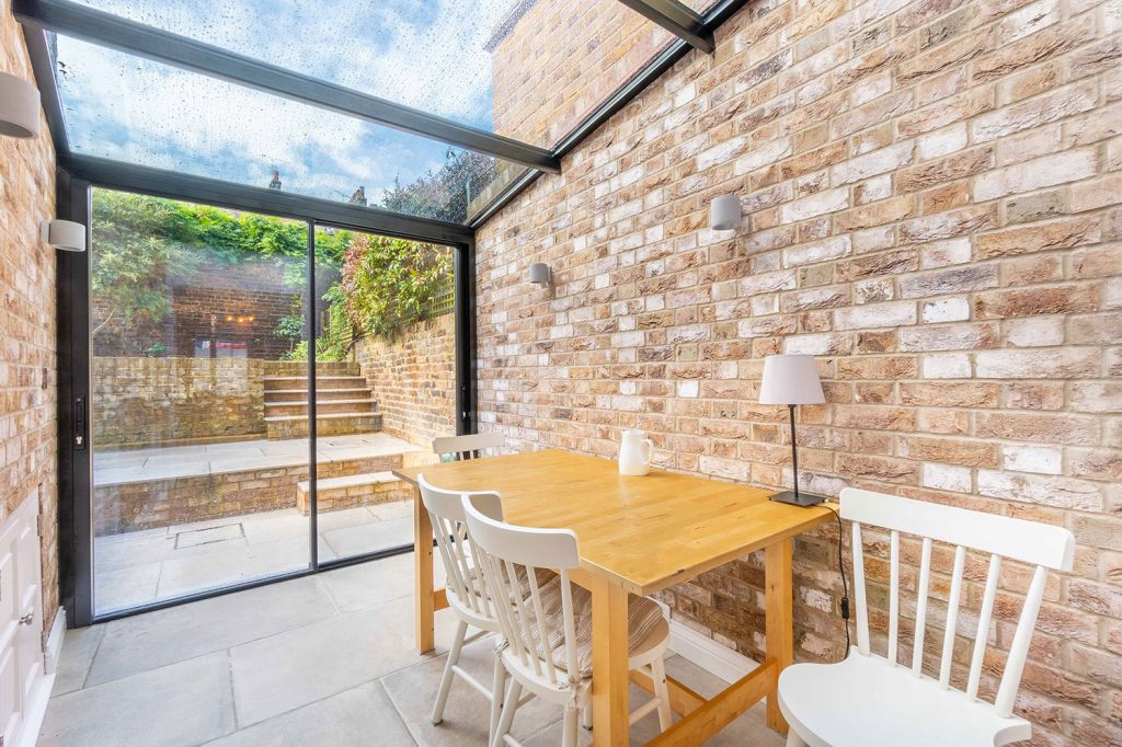 Listed Building Grade II glass structures storey extension and new build brickwall along with internal reconfiguration and landscaping.